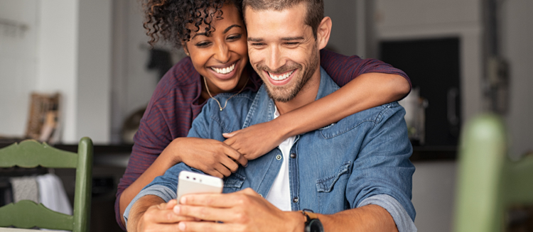 Couple using smartphone to access mobile app