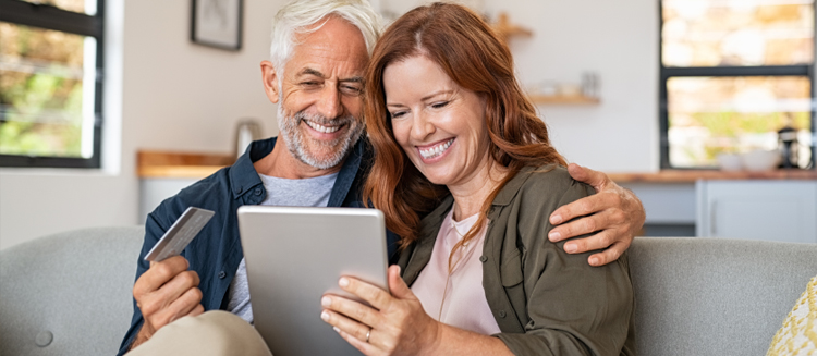 Couple paying bills on their tablet